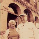 Sophie and Leo McCaughey in front of Saugy building located on Canal St in Providence. At the age of 12, Leo McCaughey, grandfather of the current owner, started working for the Saugy brothers driving a horse-drawn wagon along the cobblestone streets of Providence.